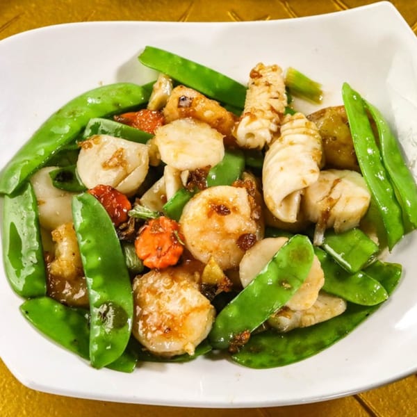 Jazmine's Asian stir-fried scallops and squid with bright green snow peas and carrots.